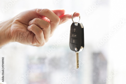 Hand with a car key. salesman with car sales photo