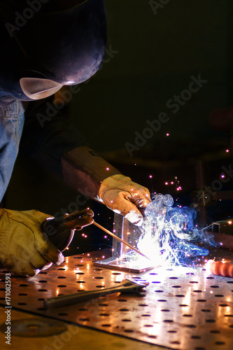 Worker produces arc welding products
