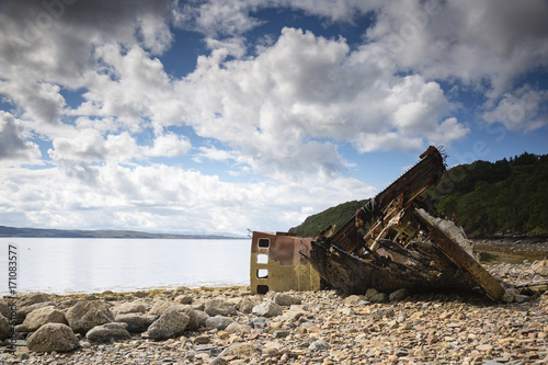 view towards a shipwreck on a stone beach in northern scotland