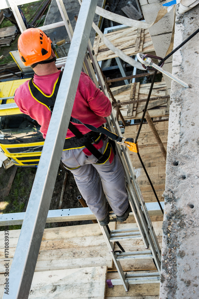 Height work on building and safety. Belaying the worker during work on a scaffolding.