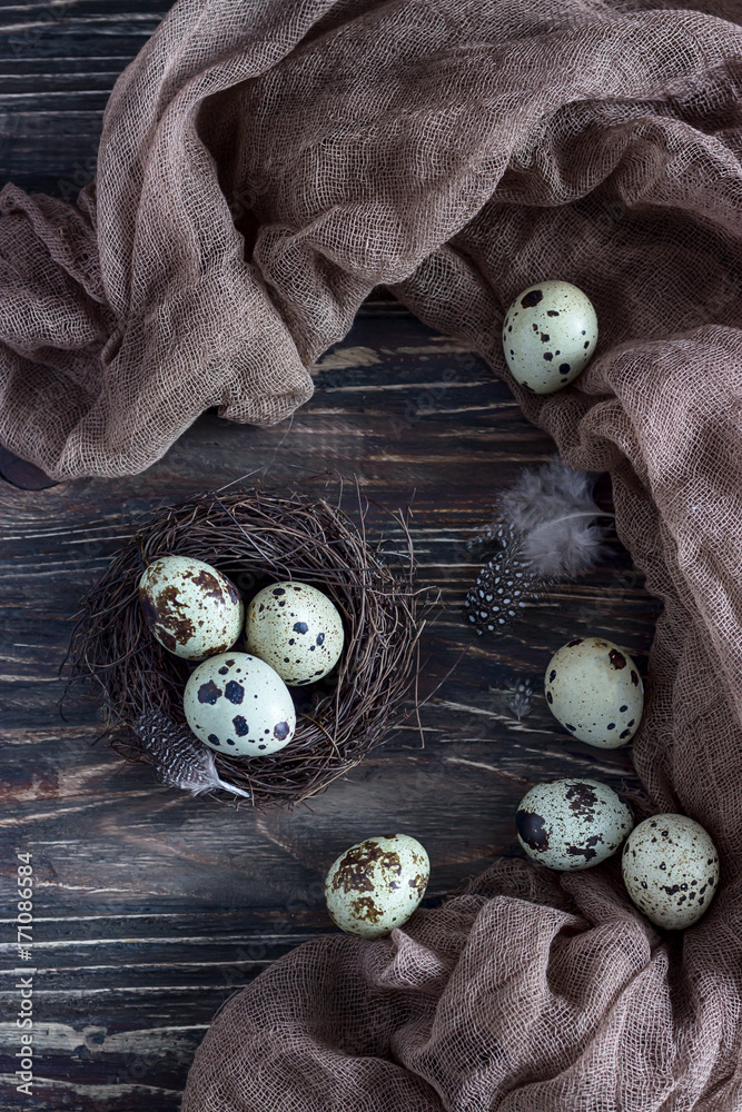 Quail eggs in a nest on a dark wooden background. Quail eggs in a nest on a dark wooden background.