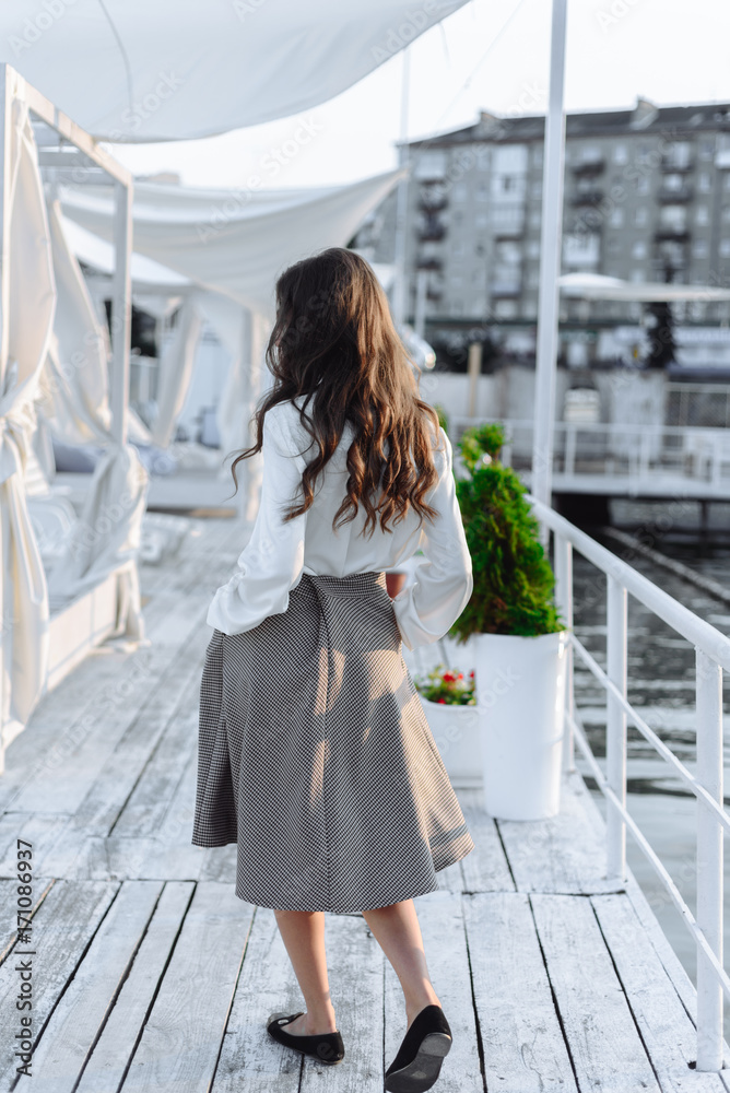 Fototapeta premium fashion portrait of happy beautiful girl in white shirt and casual dress