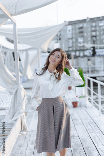 fashion portrait of happy beautiful girl in white shirt and casual dress © romanets_v