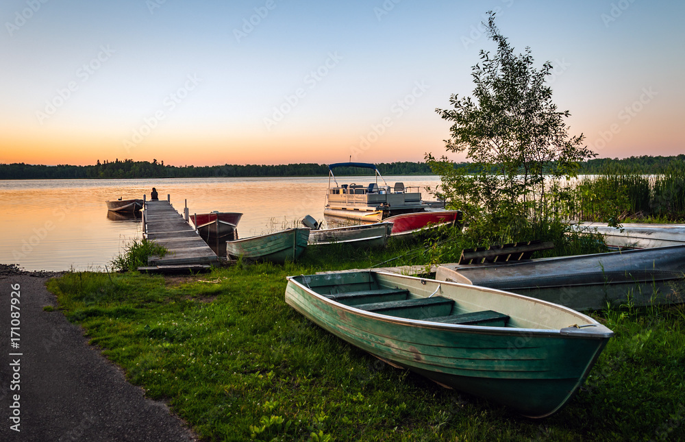 Fishing boats on tranquil lake at sunset in Minnesota