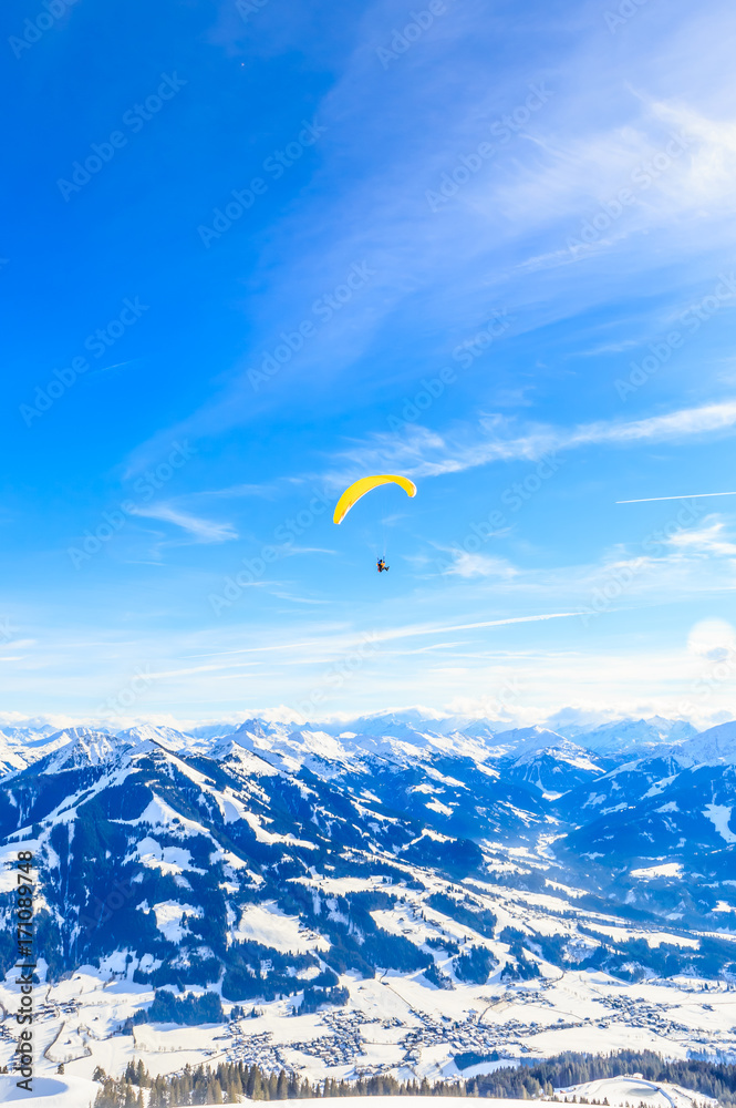 Paragliding over the mountains in winter. Ski resort Hopfgarten, Tyrol, Austria Paragliding over the mountains in winter. Ski resort Hopfgarten, Tyrol, Austria