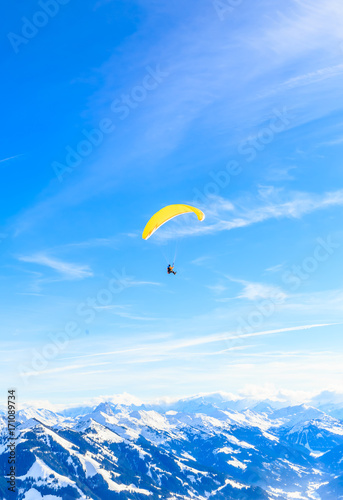 Obraz na płótnie Paragliding over the mountains in winter. Ski resort Hopfgarten, Tyrol, Austria w salonie