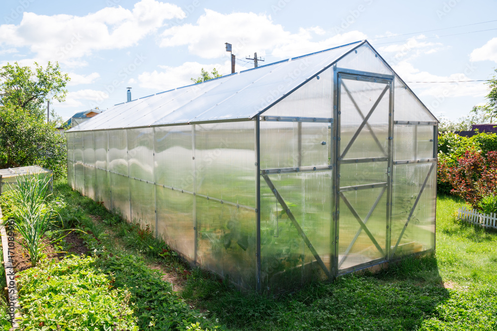 Greenhouse made of polycarbonate with a triangular roof Greenhouse made of polycarbonate with a triangular roof