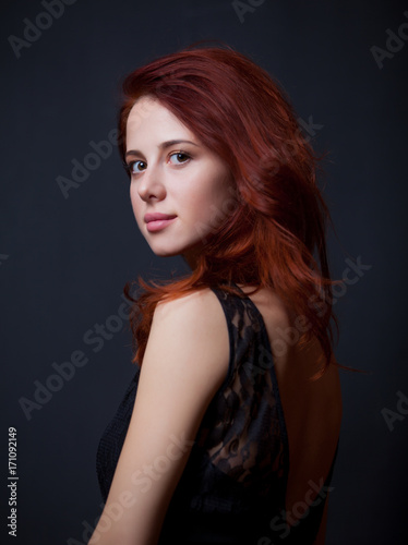 Young redhead woman in black dress