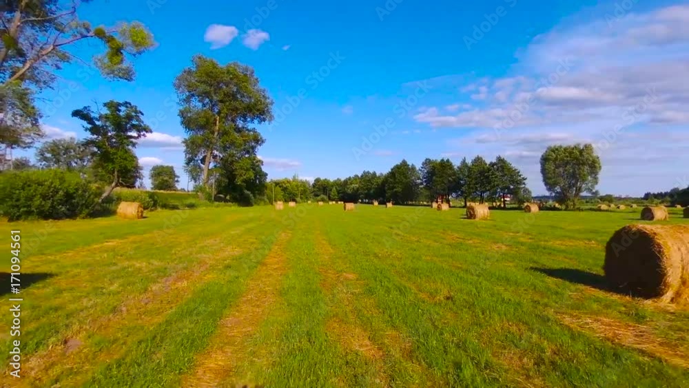 flying over hay bales in a field flying over hay bales in a field