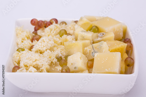 Set of cheeses and grapes on a white background
