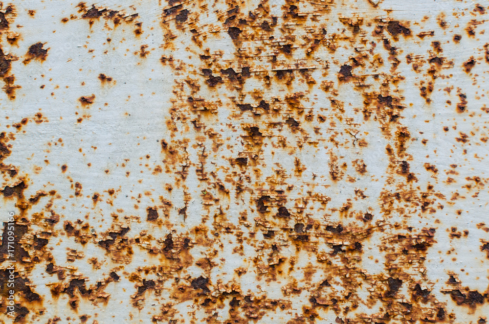 Old white paint on a rusty metal plate, texture
