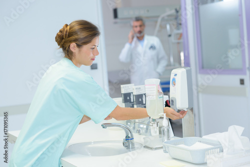 beautiful nurse washes hands