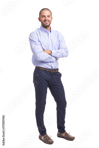 Young business man standing with arms crossed on a white background