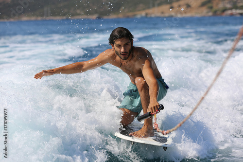 Canvas Print Young man surfing on the wave.