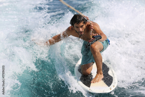 Canvas Print Young man surfing on the wave.