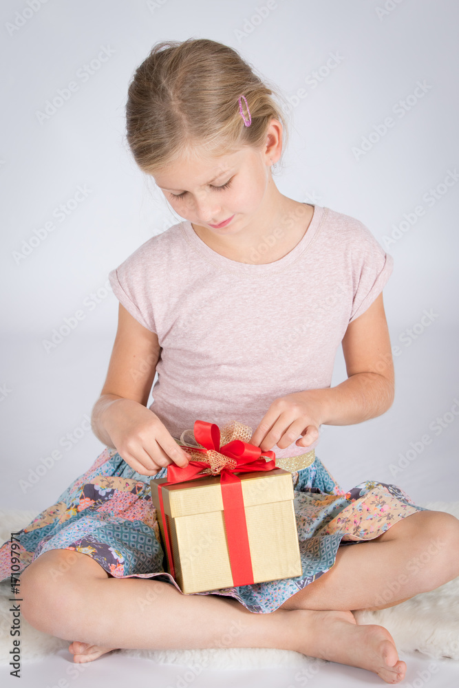 Girl opening Christmas or birthday present Girl opening Christmas or birthday present