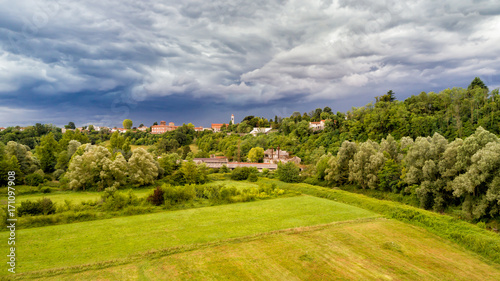 Dark heavy clouds warn of storm coming over field of Fagnano Olona in Italy. 