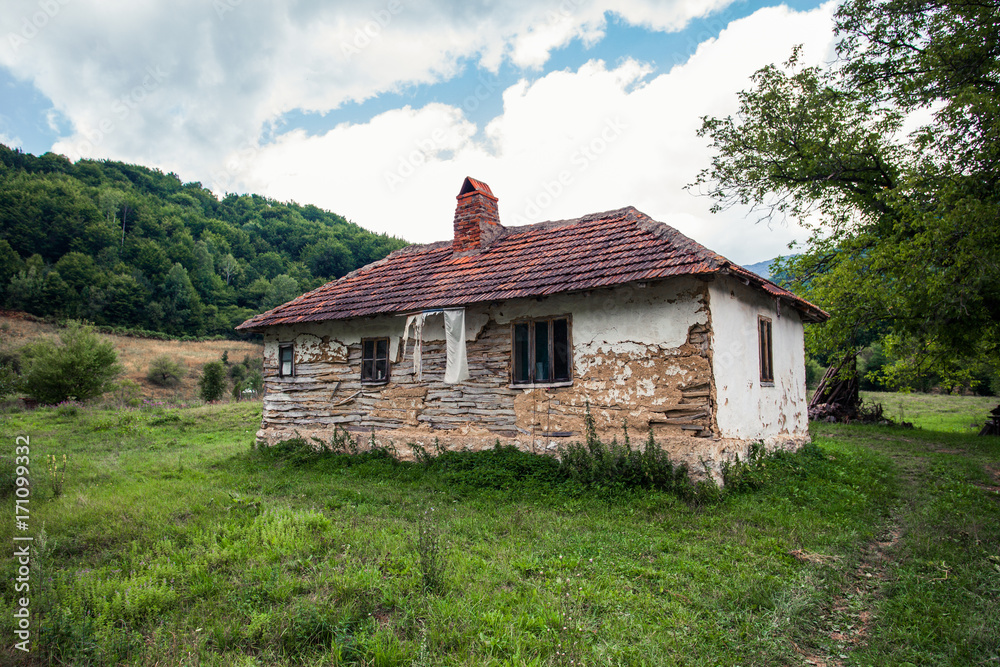 abandoned old house in rural  mountain landscape