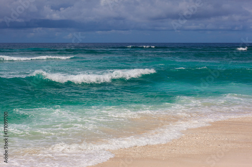 Indian ocean texture. Turquoise sea water with white foam and big wave. Powerful and peaceful nature concept.