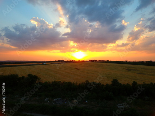 Aerial view of beautiful village, houses, roads. Sky, clouds, sunset.