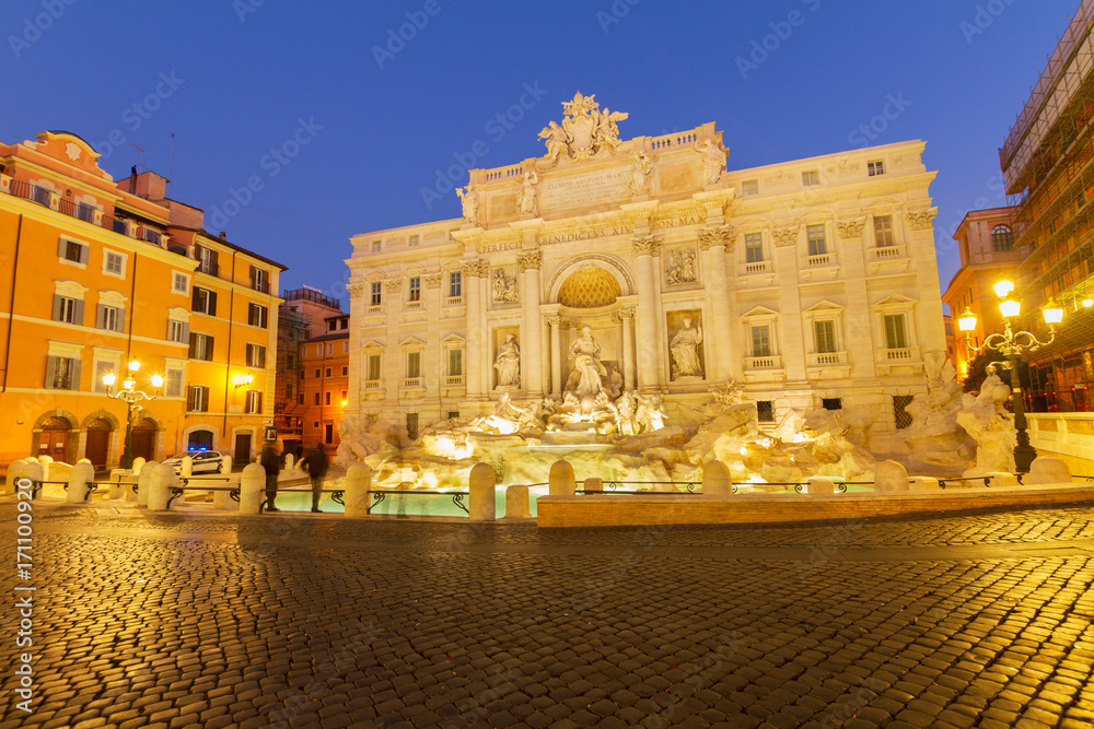 view of famous restored Fountain di Trevi in Rome illuminated at night, Italy