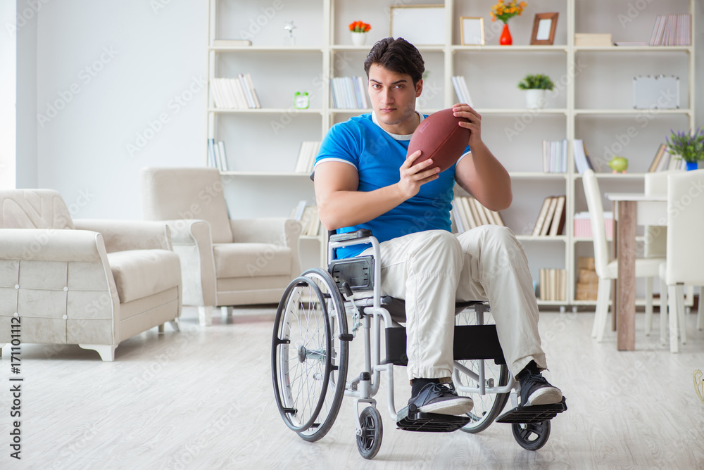 Young man american football player recovering on wheelchair
