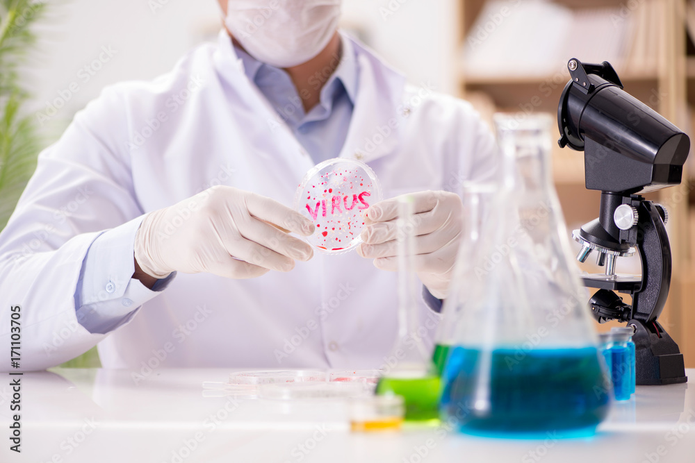 Male doctor working in the lab on virus vaccine Male doctor working in the lab on virus vaccine