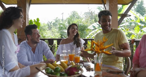 Happy People Group On Summer Terrace Talking, Diverse Friends Together Sitting At Table Drinking Juice Slow Motion 60
