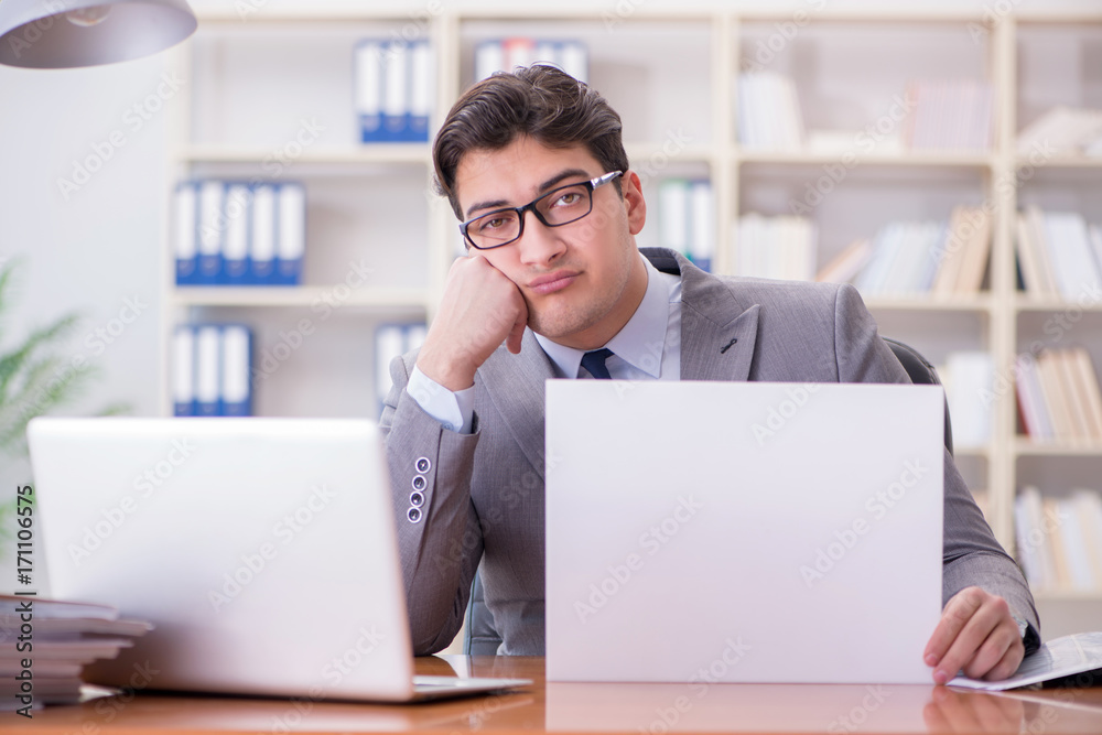 Businessman in office holding a blank message board Businessman in office holding a blank message board