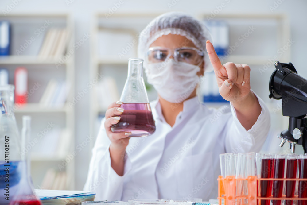 Female scientist researcher conducting an experiment in a labora Female scientist researcher conducting an experiment in a labora
