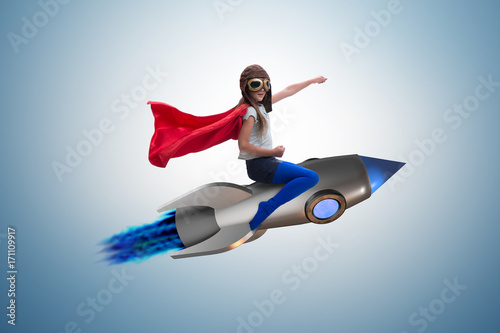 Little girl flying rocket in superhero concept © Elnur