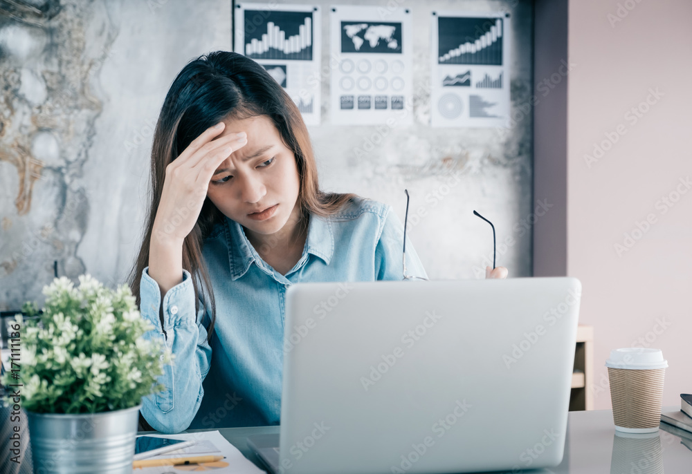 Stressed Asian creative designer woman cover her face with hand and feel  upset from work in front of laptop computer on desk at office,Stress office  lifestyle concept Stock Photo | Adobe Stock