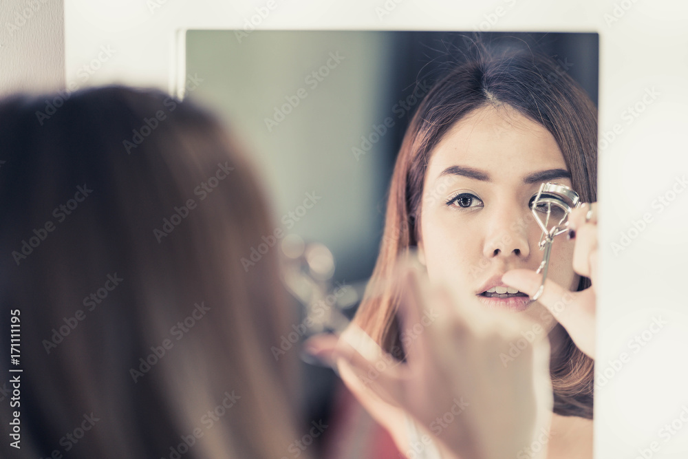 Young Beautiful Asian Woman making make-up near mirror Young Beautiful Asian Woman making make-up near mirror