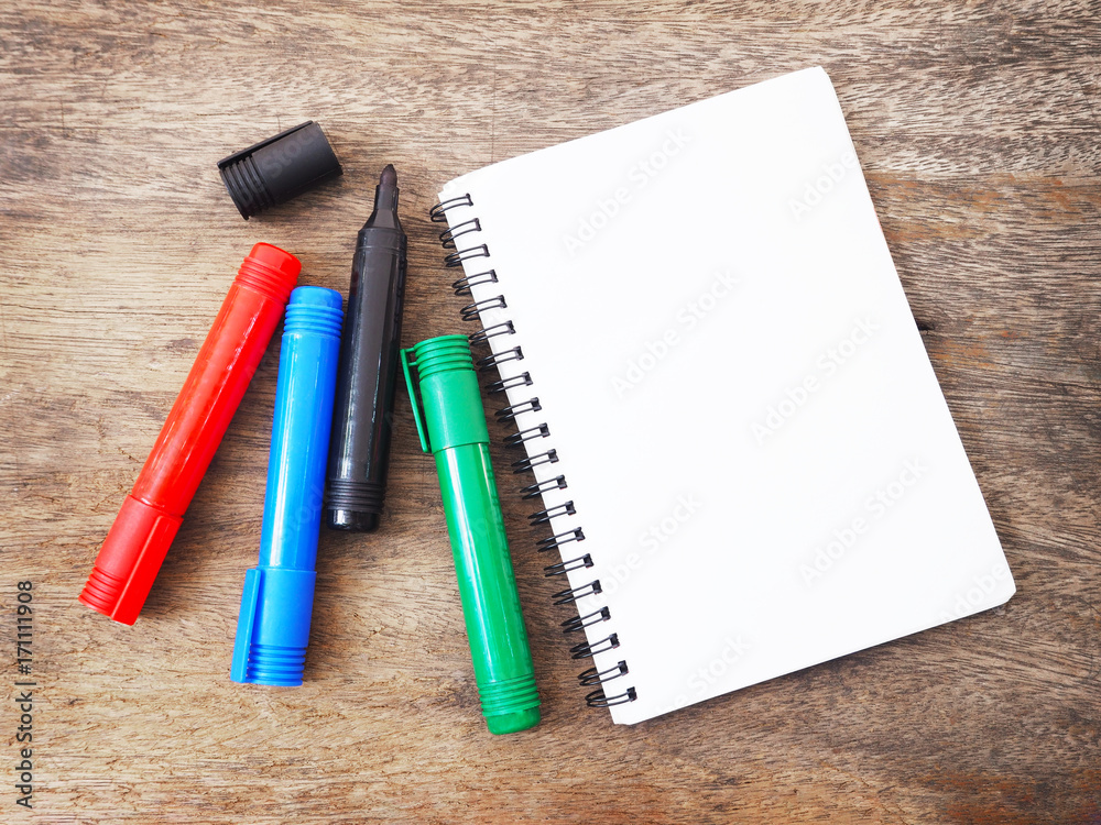 marker pens and notebook on wooden background. Top view. marker pens and notebook on wooden background. Top view.
