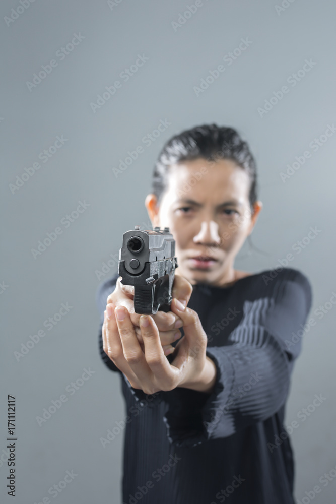 Portraits serious Asian Woman in position ready to shoot. Portraits serious Asian Woman in position ready to shoot.