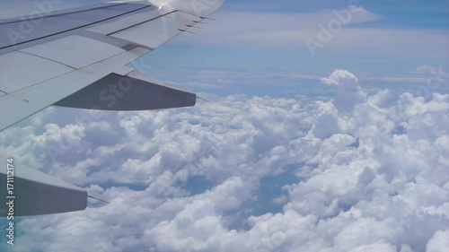 view from the airplane window, fluffy clouds