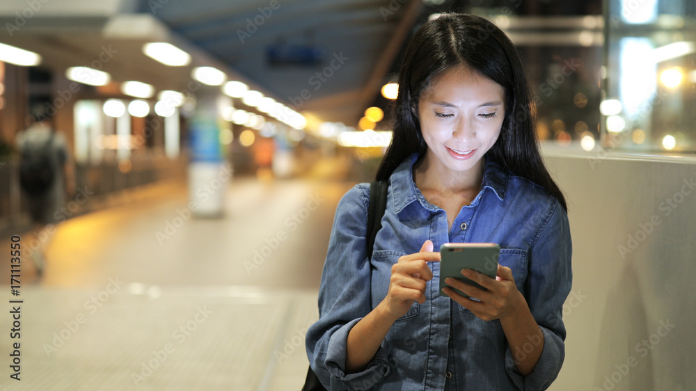 Woman using mobile phone at night Woman using mobile phone at night