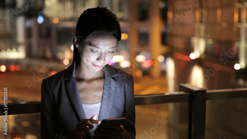 Photography Business woman use of mobile phone at night