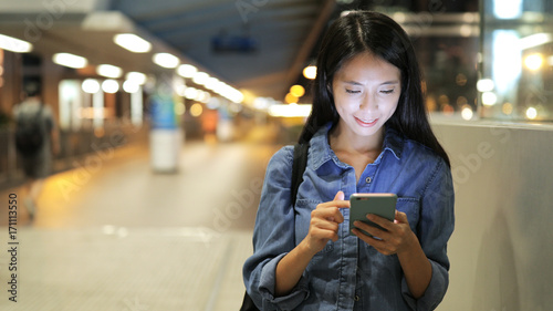 Tableau sur toile Woman using mobile phone at night
