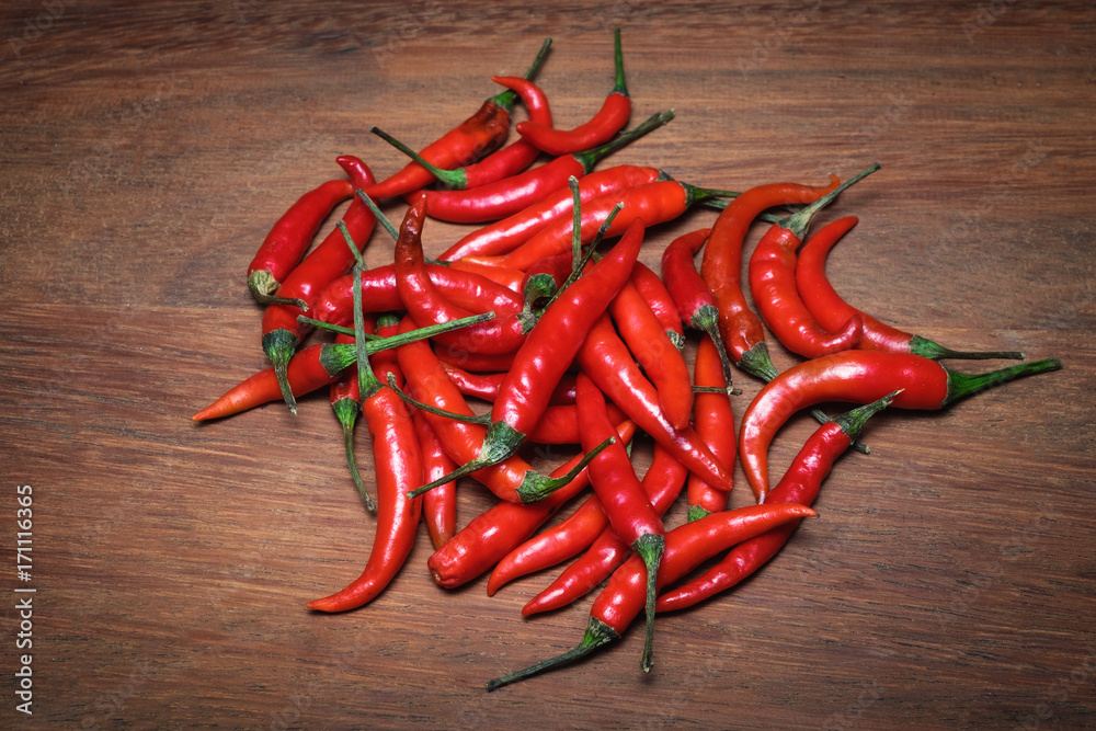 Red chilli on wooden background using fresh red., It has spicy., food concept., Top view 