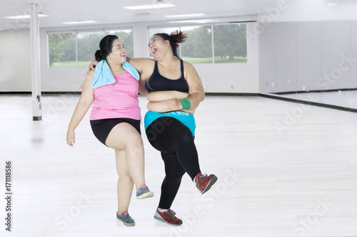 Fat women exercising together