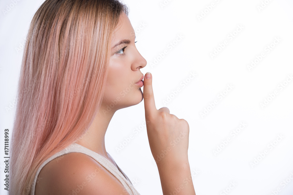 Young beautiful woman has put forefinger to lips as sign of silence. Shhh concept Young beautiful woman has put forefinger to lips as sign of silence. Shhh concept