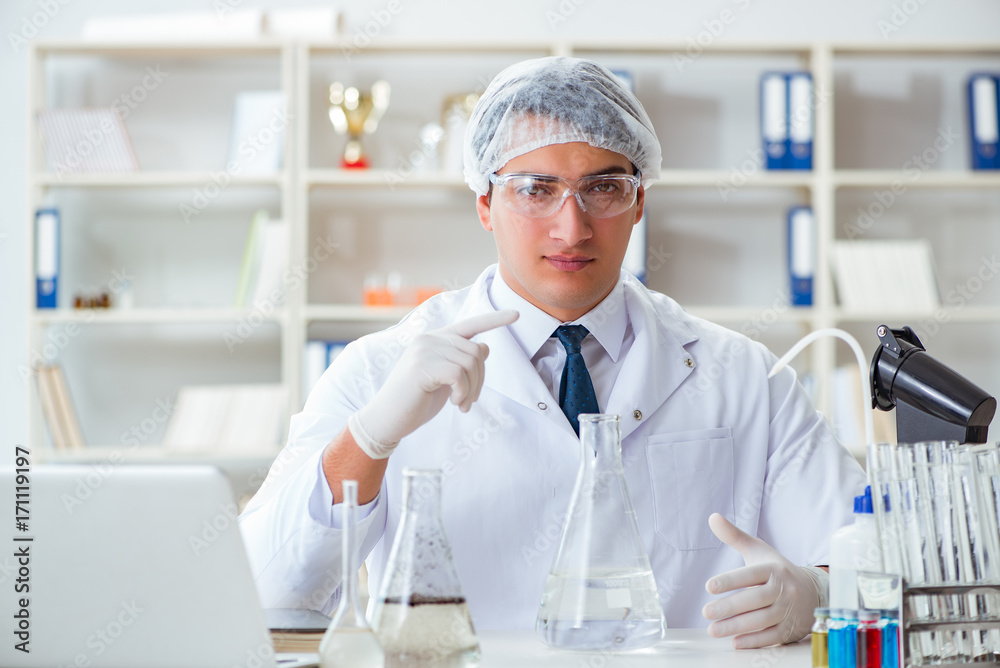 Young researcher scientist doing a water test contamination expe Young researcher scientist doing a water test contamination expe
