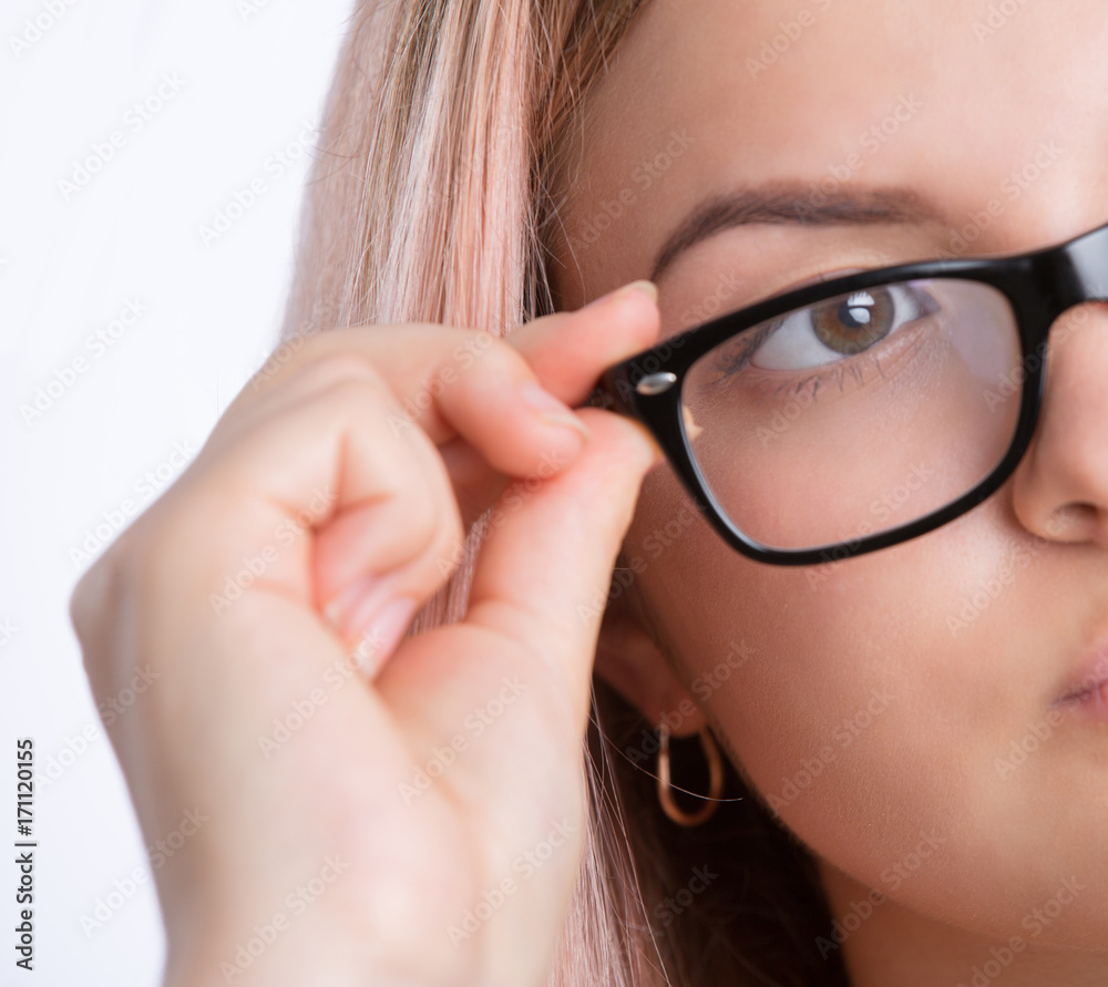 Closeup of young pretty woman wearing eyeglasses looking away Closeup of young pretty woman wearing eyeglasses looking away