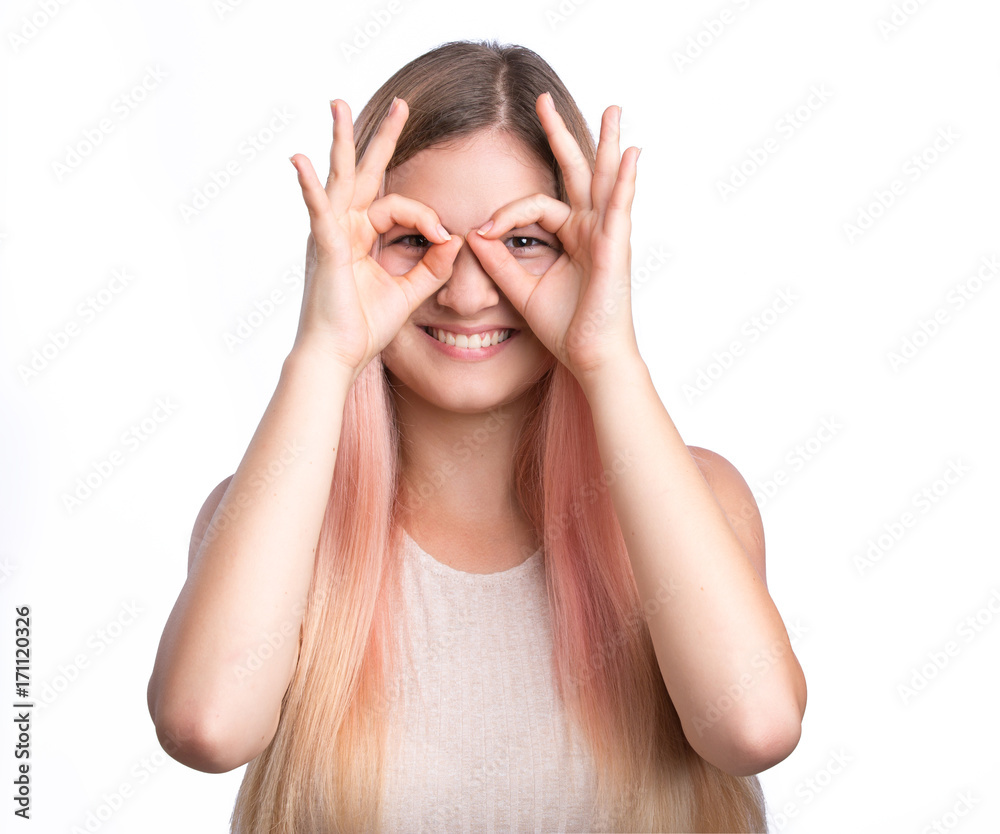 Beautiful young playful woman with hands near eyes making goggles Beautiful young playful woman with hands near eyes making goggles