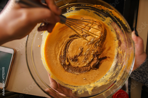 Принти на полотні pumpkin pie recipe concept - woman whisking in cinnamon and spices for batter sh