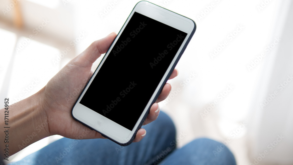 Woman hand holding phone. People using smart phone working from home.