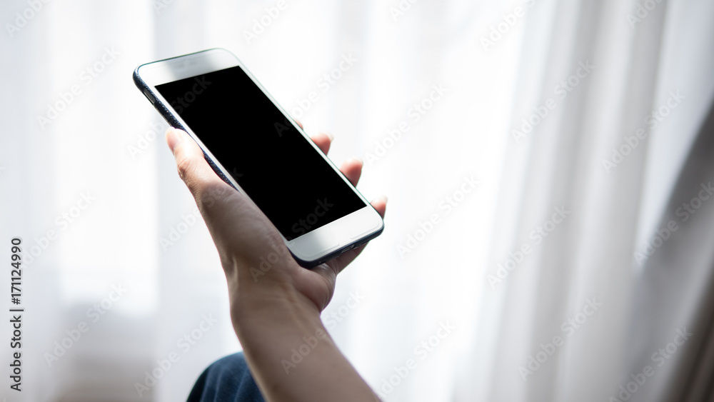 Woman hand holding phone. People using smart phone working from home.