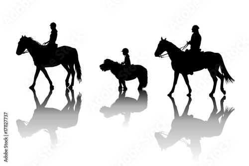 Family riding horses and pony