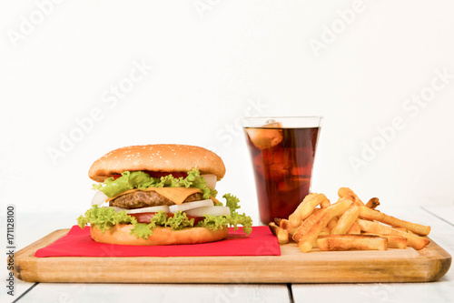 Home made hamburger with french-fries and soft drink . close-up
